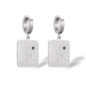 Macro detail of silver tarot card earrings with blue gemstones and star engravings
