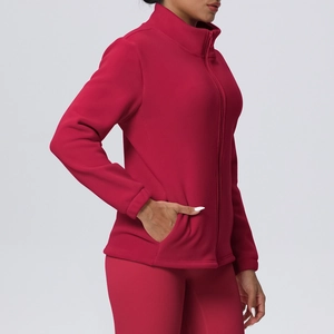 Detail of burgundy fleece sports jacket with high collar and zipper for women