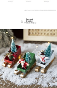 Detailed view of Santa, snowman and deer sleigh Christmas ornaments in a festive scene