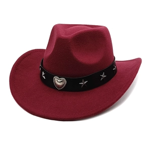 Detail of burgundy felt cowboy hat featuring silver heart buckle and star rivets