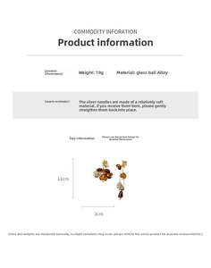 Detail view showing amber asymmetric tassel earrings with 11cm length and silver needle studs