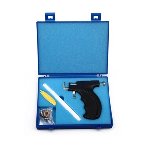 Detailed ear piercing gun kit with pen, tweezers and studs in a blue storage box
