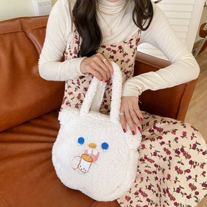 Close-up of white plush bear ear handbag with cute embroidery and soft fuzzy texture
