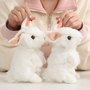 Lifelike white plush rabbit dolls with soft long fur and pink inner ears held by hands