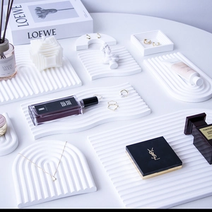 White wave and arched gypsum storage trays with striped texture for jewelry display