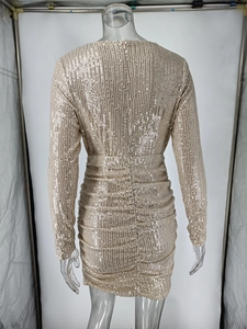 Rear view of gold sequin V-neck dress featuring ruched waist and hidden zipper detail