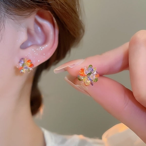 Macro detail of colorful crystal cluster stud earring with floral woven design