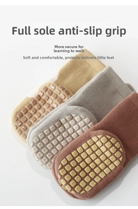 Detail of toddler grip socks with non-slip silicone pads on soles in three colors