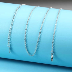 Macro shot of silver stainless steel chain with lobster clasp and adjustable extension link