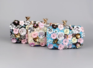 Three elegant beaded evening bags with 3D handmade floral petals and crystal clasps