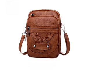 Detail view of brown PU leather crossbody bag with triple zippers and woven texture