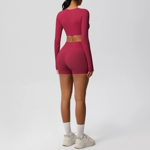 Detail of crop top back and high waist shorts in stretchy magenta athletic fabric