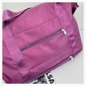 Close-up of purple travel bag showing water-resistant nylon fabric and reinforced seams