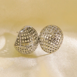 Pair of silver hollow mesh hemispherical stainless steel earrings on gold silk fabric