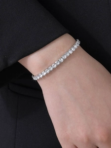 Close-up of sparkling silver tennis bracelet with cubic zirconia on a model's wrist
