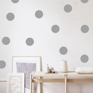 Modern gray polka dot wall stickers on white wall in a minimalist living room setting