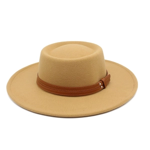 Close-up of camel wool boater hat with dark brown leather strap and metal rivet details