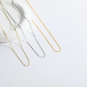 Versatile gold and silver stainless steel chain necklaces displayed on white stand