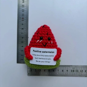 Detailed view of hand-knitted positive watermelon doll measuring 7.5cm with card