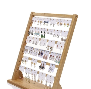 Detail of multi-tier bamboo jewelry display stand holding various earring cards