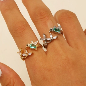 Exquisite hummingbird rings in gold and silver with green emerald-cut stones and zircon