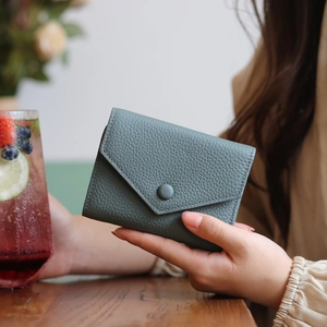 Slim genuine leather bifold wallet in Morandi green with envelope flap and card slots