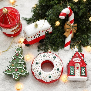 Christmas tree ornaments set featuring gingerbread house, candy cane, and carousel on snow