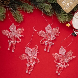 Detail of transparent acrylic angel ornaments with festive red background and pine branches