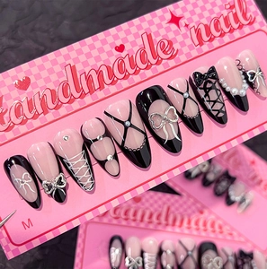 Detail of pink and black handmade nails with pearls, 3D bows and ballet laces