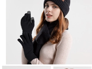 Detailed view of black knitted winter set with beanie, scarf and touch screen gloves