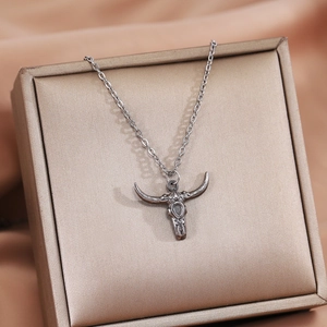 Silver bull head pendant necklace in a premium beige jewelry box, minimalist style
