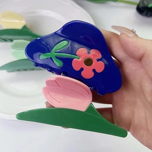 Floral acetate hair claw clip with pink tulip and green leaves in blue contrast