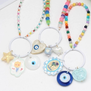 Detail of DIY phone charms with colorful beads, evil eye pendants and nice lettering