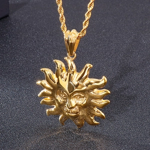 Macro detail of golden sun face pendant with textured twist rope chain for men