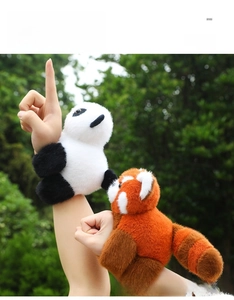 Outdoor shot of plush panda and red panda snap bracelets worn on the wrist in nature