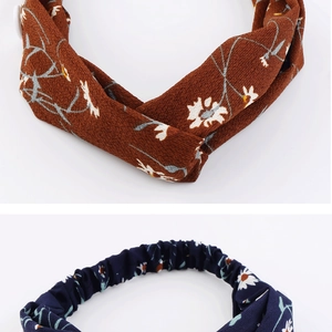 Detail of daisy pattern chiffon headbands in brown and navy with twist knot design