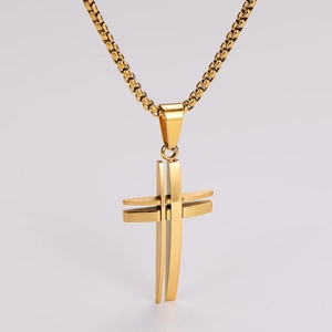 Macro shot of gold stainless steel hollow cross pendant with detailed bead chain