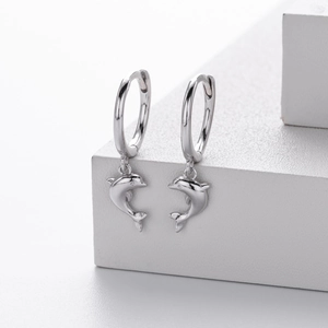 Close-up of polished S925 sterling silver hoop earrings with elegant dolphin pendants