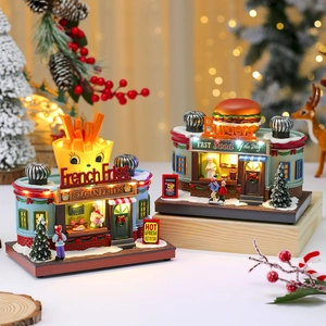 Lighted Christmas music box village with miniature burger and french fries shops