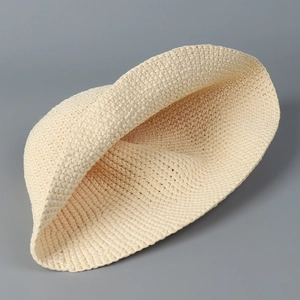 Minimalist beige woven straw bucket hat for women with a natural handmade texture