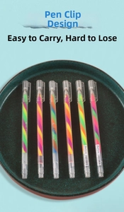 Detailed view of six rainbow gradient ink pens organized in a green tray on blue background