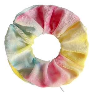 Detail of pink and yellow tie-dye velvet scrunchie with high elasticity and soft texture