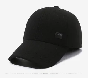 Detail view of the black wool texture and rectangular logo patch on the side of the cap
