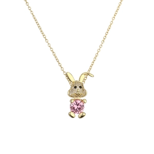 Golden rabbit necklace with sparkling diamonds and a large pink zircon on white background