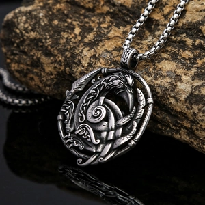 Detailed macro view of vintage Viking crow pendant with Celtic knotwork on stone