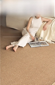 Detail view of woven art rug texture in natural beige, durable sisal-like fiber material