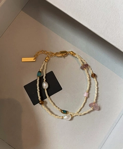 Detail of double-layer bracelet with freshwater pearls, glass beads and gold plated clasp