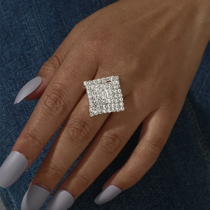 Macro shot of a sparkling square pavé ring with white crystals on silver metal band