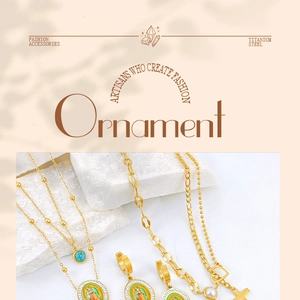 Detail of gold titanium steel jewelry set with enamel pendants and turquoise accents