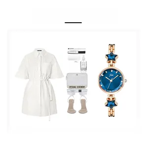 Elegant gold bracelet watch with starfish accents and deep blue dial displayed on white